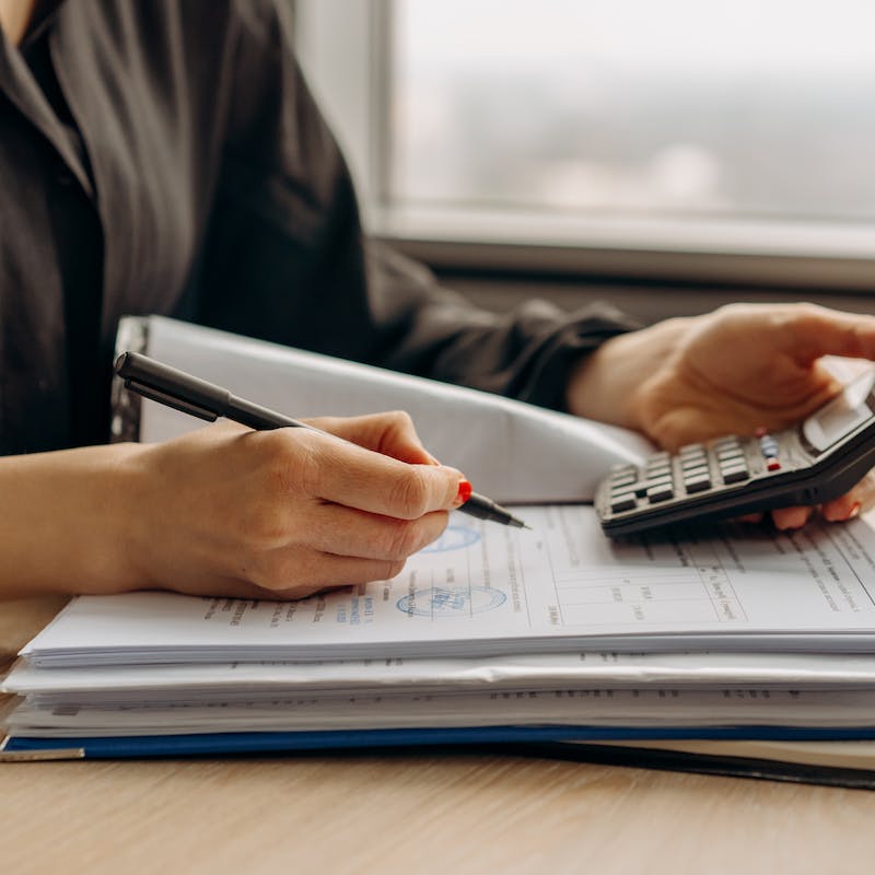 woman's hand using a calculator